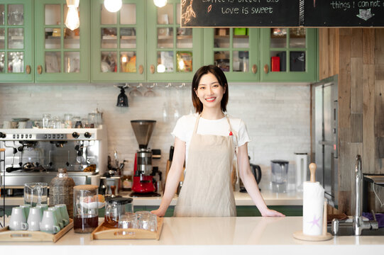 Young cafeteria waitress standing in counter