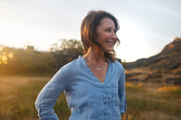 Confident, content mature woman portrait at sunset