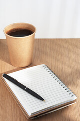 Notebook, pen and coffee cup