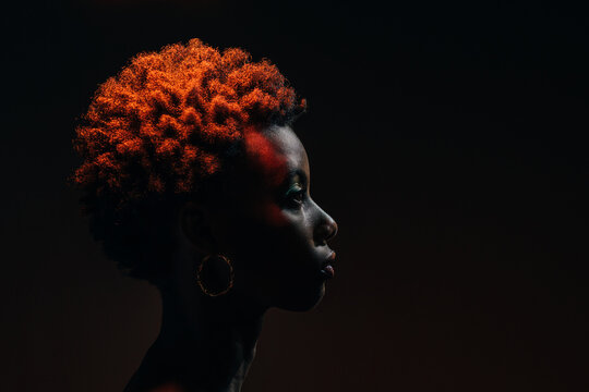 Side view of african woman posing in the studio