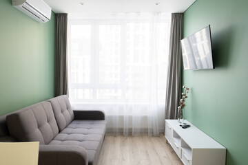 A small room with sofa and tv