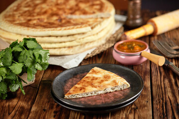 National traditional Caucasian cuisine: Ossetian pies, khachapuri, chudu. Assorted pies with different fillings: meat, cheese, herbs
