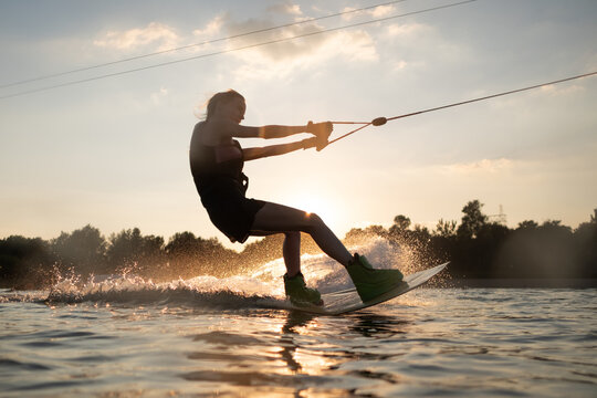 Woman Surfing On A Wakeboard