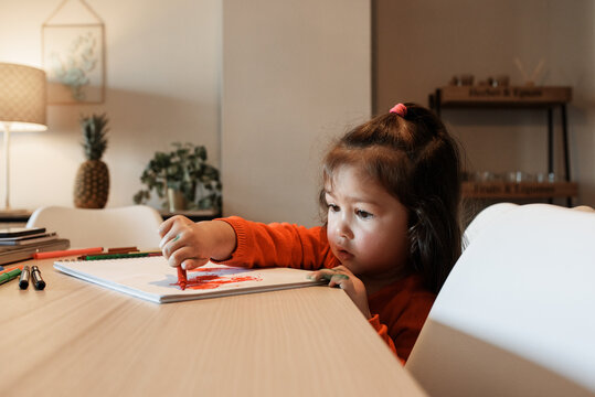 Ethnic girl drawing sketch on table