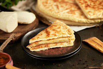 National traditional Caucasian cuisine: Ossetian pies, khachapuri, chudu. Assorted pies with different fillings: meat, cheese, herbs