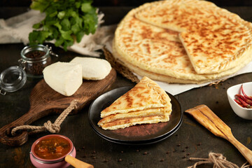 National traditional Caucasian cuisine: Ossetian pies, khachapuri, chudu. Assorted pies with different fillings: meat, cheese, herbs
