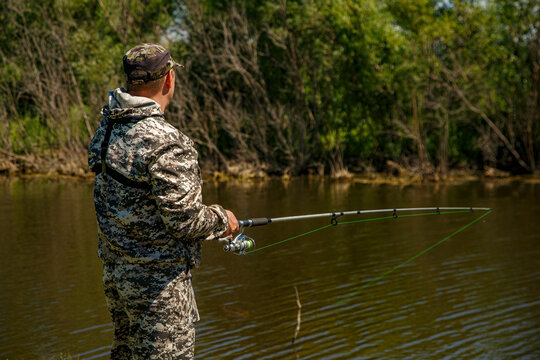 Unrecognizable man fishing in lake