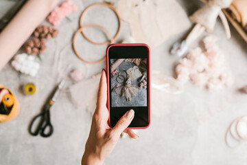 Woman making composition of handmade doll