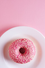 Pink donut on a plate