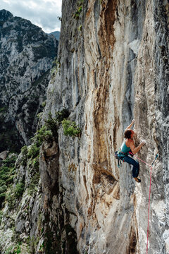 Young climber woman looking her next movement