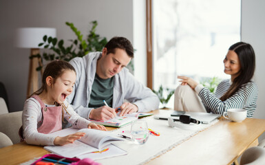 Parents with school girl indoors at home, distance learning and home office.