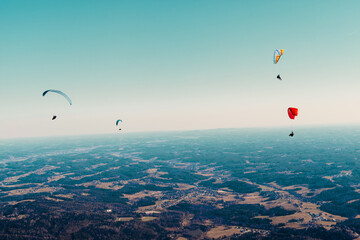sports paragliding on a parachute over the countryside