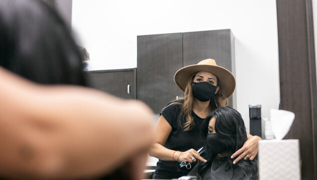 Style: Stylist Wearing Face Mask Trims Customer's Hair With Scis