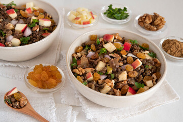 Bowl of vegetarian mixed salad, with lentils, apples, nuts and spices