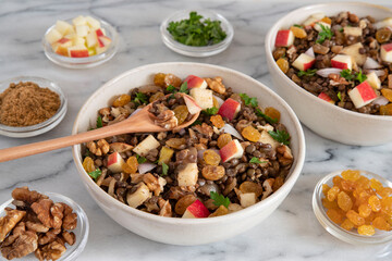Bowl of vegetarian mixed salad, with lentils, apples, nuts and spices
