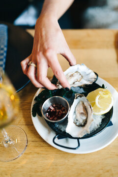 newly wed eating oysters with citron and sauce