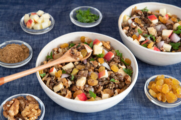 Bowl of vegetarian mixed salad, with lentils, apples, nuts and spices