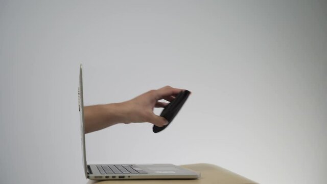 Stealing a purse through a laptop concept for computer hacker, network security and electronic banking security