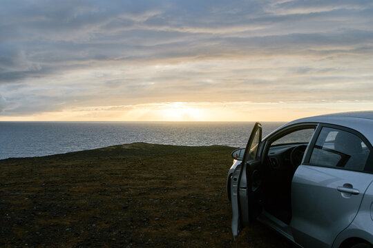 car on the view point of the ocean sunset