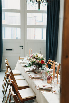 romantic table setting with flowers for a gathering indoors