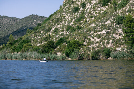Unrecognizable man kayaking on lake