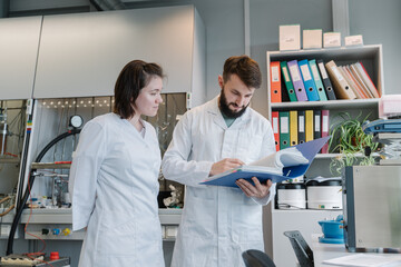 Two Researchers Working With Documents