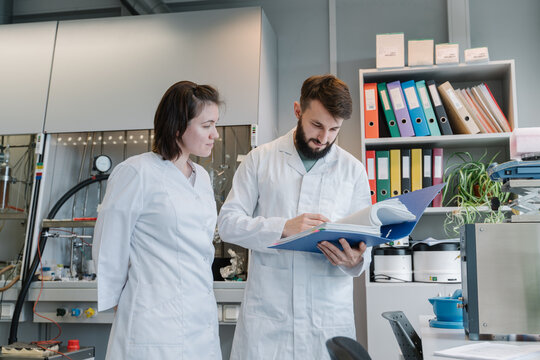Two Researchers Working With Documents