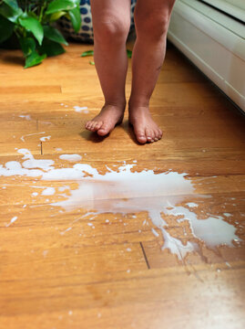 Toddler Feet Next to Spilled Milk