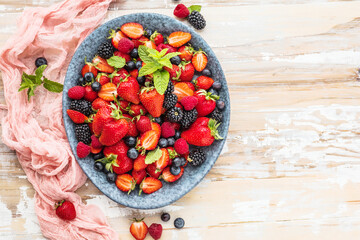 Berries colorful assorted mix of strawberry, blueberry, raspberry, blackberry on dark background