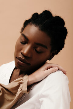 Crop model touching black woman with closed eyes