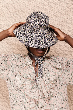 Young woman adjusting summer hat