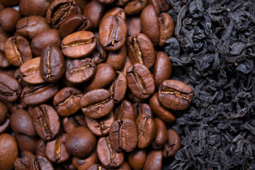 pile stack of dried tea leaves and roasted coffee beans seeds: theine vs caffeine. background