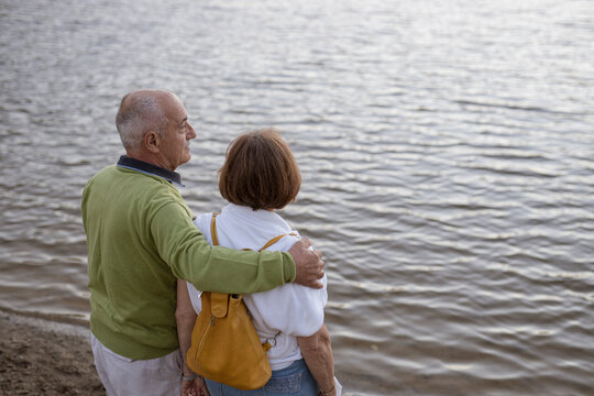 Senior couple enjoying together by the lake