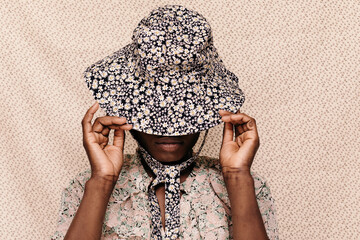 Young woman adjusting summer hat