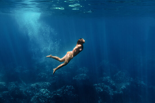 Woman diving in clear sea