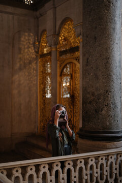 Woman taking pictures inside cathedral