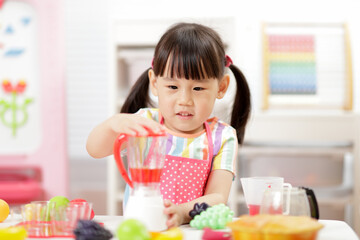 young  girl pretend play food preparing at home