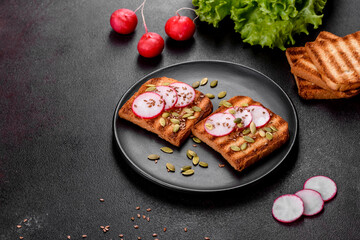 Delicious crisp sandwich with toast, radish, pumpkin seeds and flax seeds