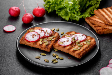 Delicious crisp sandwich with toast, radish, pumpkin seeds and flax seeds