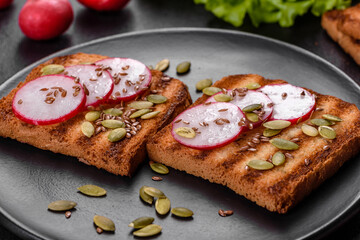 Delicious crisp sandwich with toast, radish, pumpkin seeds and flax seeds
