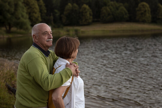 Senior couple enjoying together by the lake