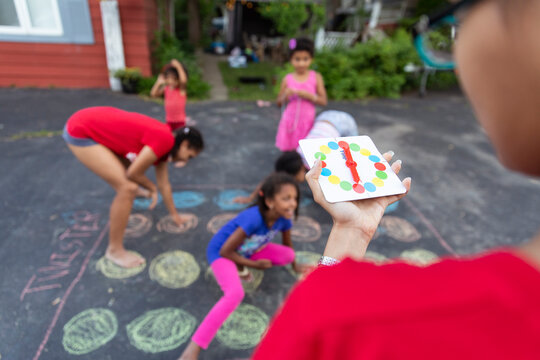 Kids outside playing summer games in the driveway