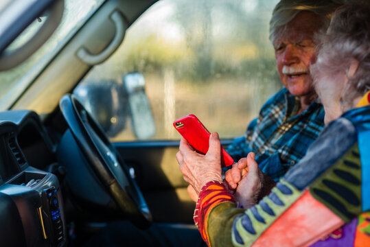 senior woman showing her husband the map on her mobile phone