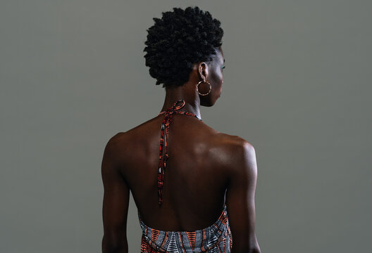 Back view of black african woman posing in the studio isolated on white background