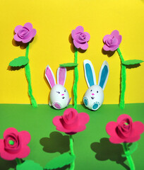 Easter bunnies from an egg on a yellow background.