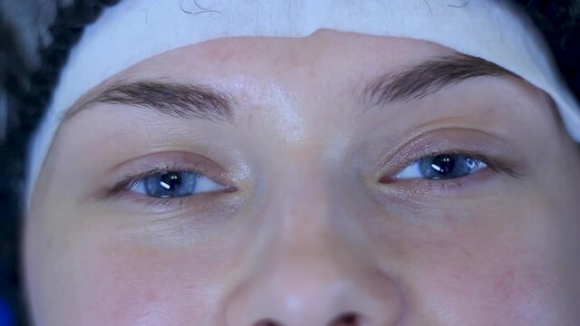 Close up BEFORE lash extentions. Caucasian woman with blue eyes