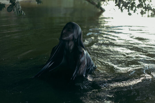 the girl covered with a wet cloth got out of the water
