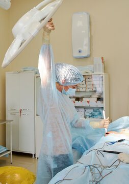 female doctor performs breast augmentation surgery for a woman