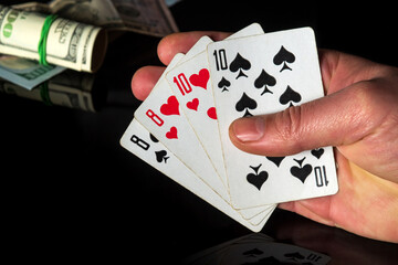 Poker cards with two pairs combination. Close up of a gambler hand is holding playing cards in casino