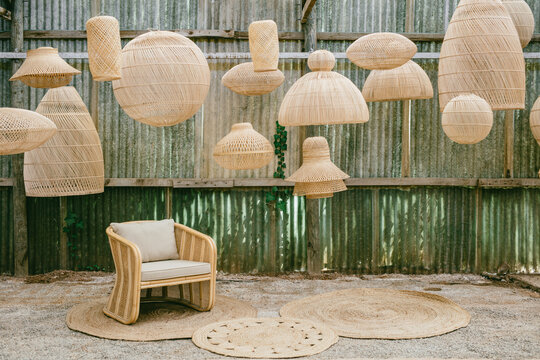 wicker armchair surrounded by lamps